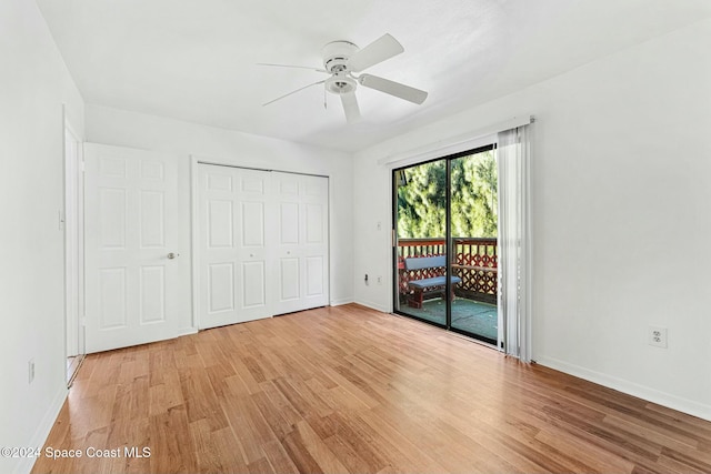 unfurnished bedroom with access to outside, a closet, light hardwood / wood-style floors, and ceiling fan