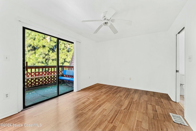 empty room with ceiling fan and wood-type flooring