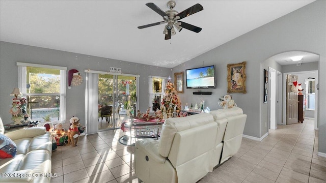 living room featuring ceiling fan, light tile patterned floors, and lofted ceiling