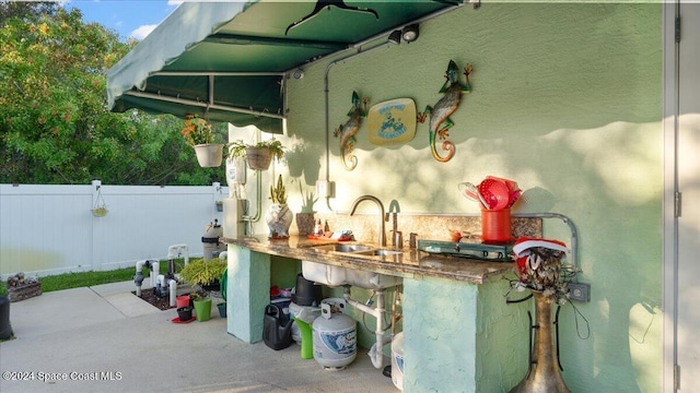 view of patio featuring an outdoor wet bar