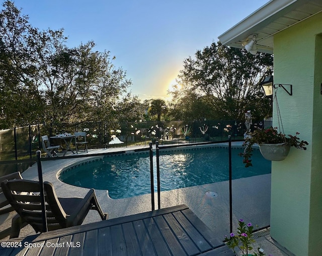 view of pool at dusk