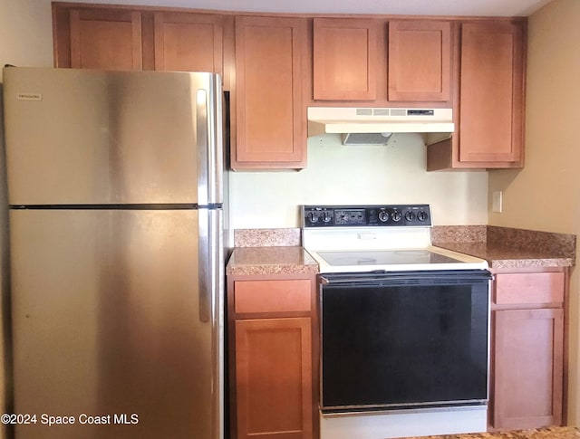 144 San Paulo Cir Unit 10-144, West Melbourne, FL 32904 - kitchen with freestanding refrigerator, under cabinet range hood, and white range with electric stovetop