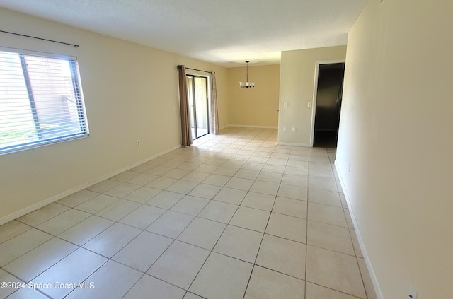144 San Paulo Cir Unit 10-144, West Melbourne, FL 32904 - spare room featuring a chandelier and light tile patterned flooring
