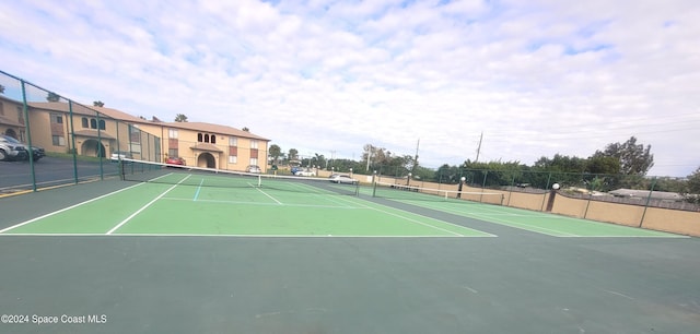 view of sport court with basketball hoop