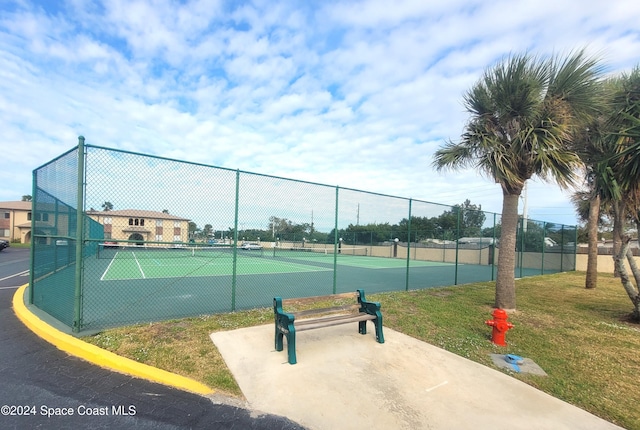 view of sport court with a lawn