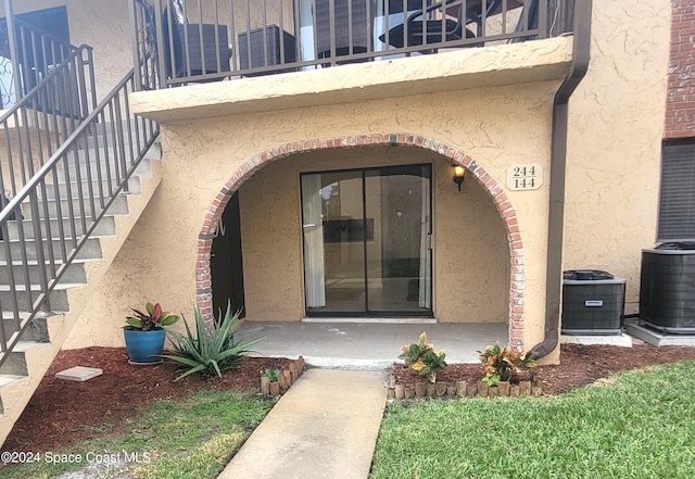 144 San Paulo Cir Unit 10-144, West Melbourne, FL 32904 - doorway to property with stucco siding and a balcony
