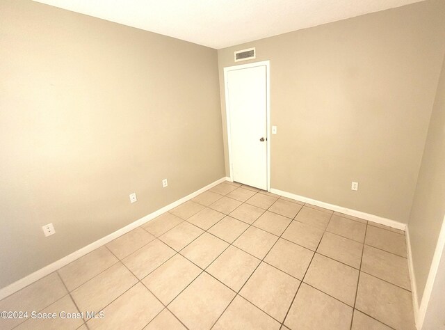 144 San Paulo Cir Unit 10-144, West Melbourne, FL 32904 - empty room featuring light tile patterned floors and baseboards