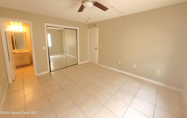 144 San Paulo Cir Unit 10-144, West Melbourne, FL 32904 - unfurnished bedroom with light tile patterned floors, a closet, and a ceiling fan
