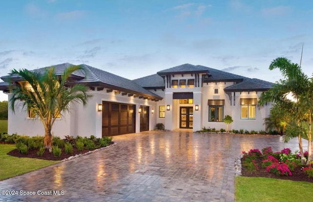 view of front of property with french doors and a garage