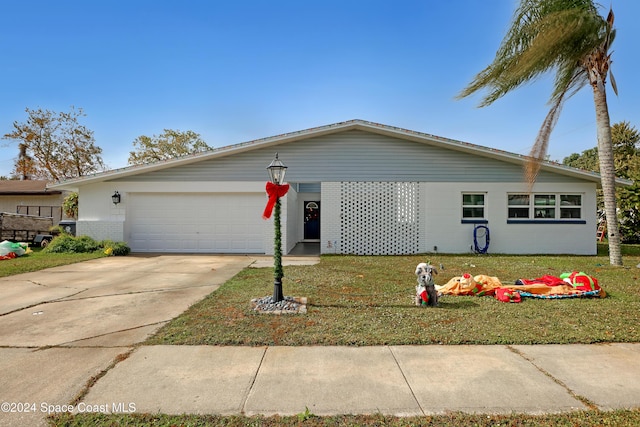 ranch-style home featuring a garage and a front yard