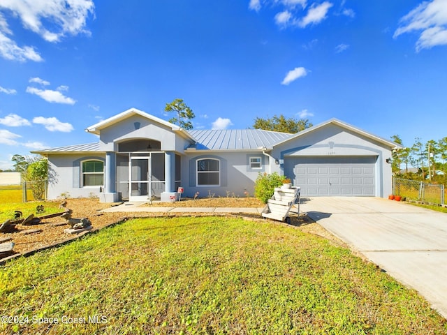 ranch-style home featuring a garage and a front lawn