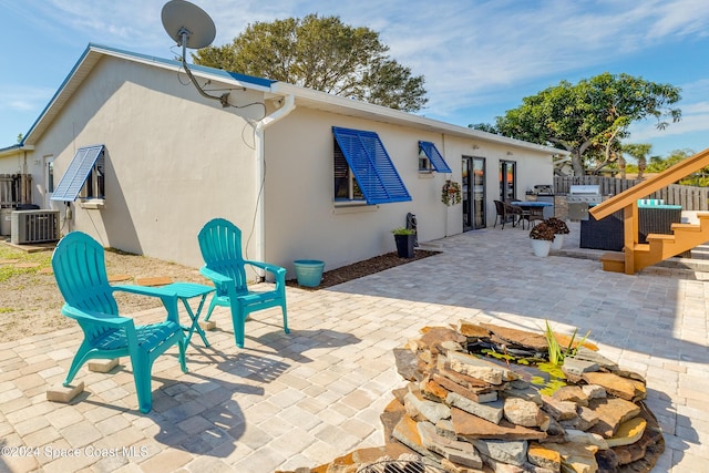 rear view of house with a patio area and central air condition unit