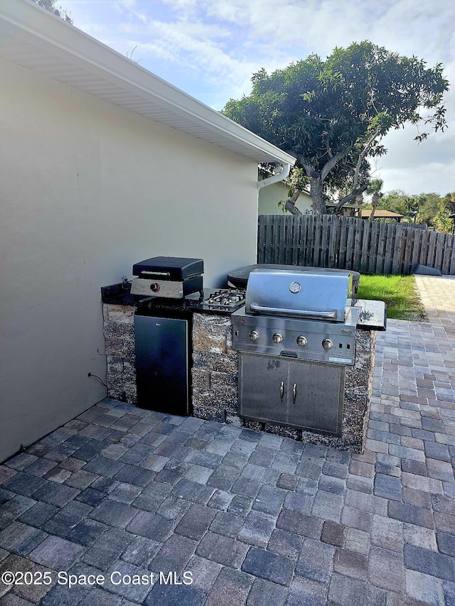 view of patio with area for grilling and exterior kitchen