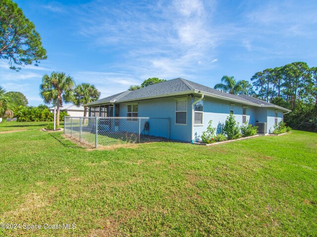 view of property exterior with a yard and cooling unit