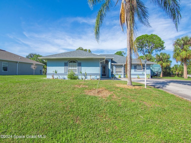 ranch-style home with a garage and a front yard