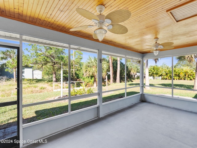 unfurnished sunroom featuring ceiling fan and wood ceiling