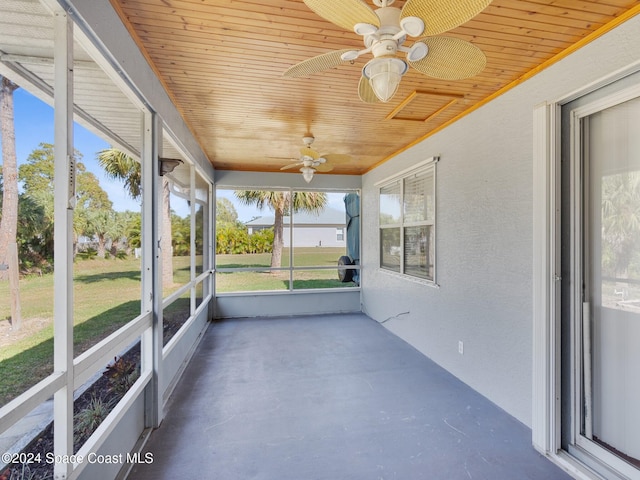 unfurnished sunroom featuring ceiling fan and wooden ceiling