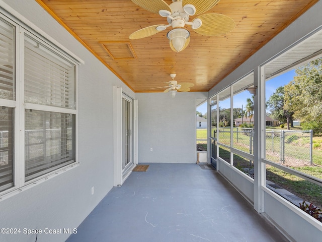 unfurnished sunroom with ceiling fan and wood ceiling