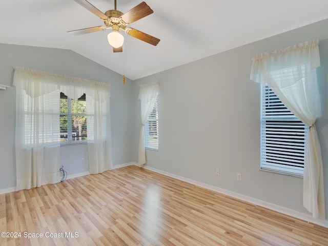 unfurnished room featuring ceiling fan, vaulted ceiling, and light hardwood / wood-style flooring