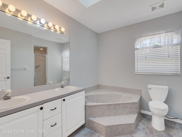 full bathroom featuring hardwood / wood-style flooring, vanity, toilet, and independent shower and bath