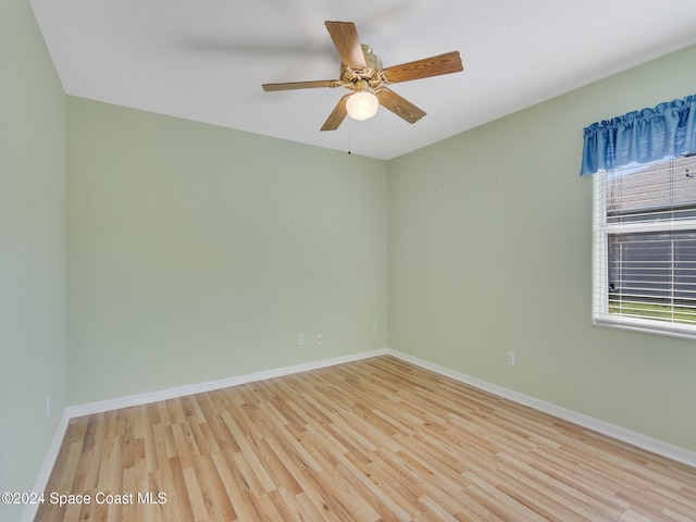 spare room with light hardwood / wood-style flooring and ceiling fan