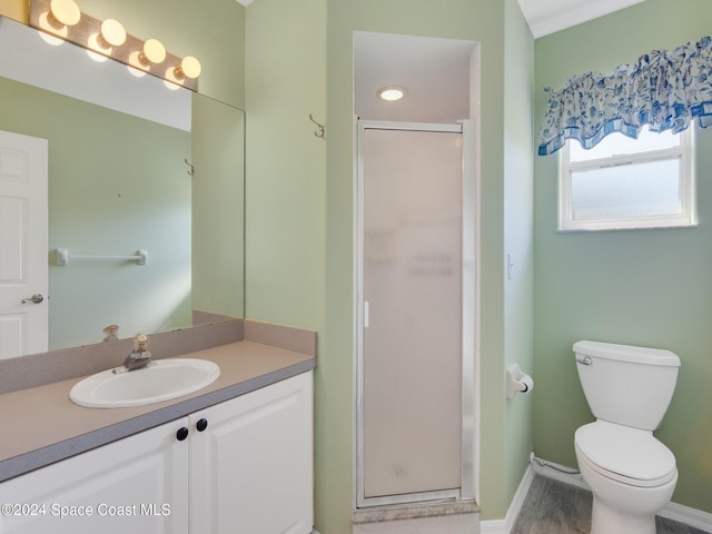 bathroom featuring vanity, toilet, and walk in shower