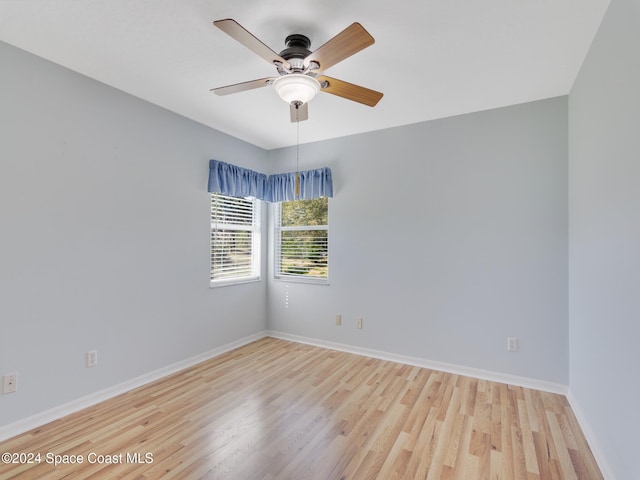 empty room with ceiling fan and light hardwood / wood-style floors