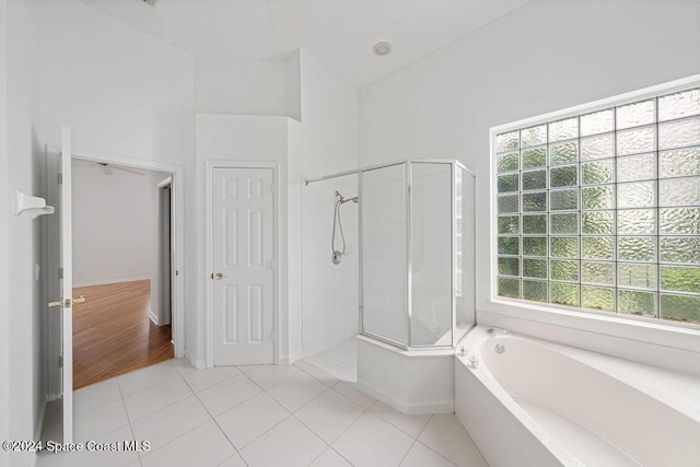 bathroom featuring tile patterned floors, plenty of natural light, and independent shower and bath