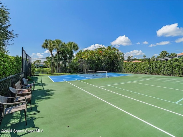 view of tennis court featuring basketball hoop