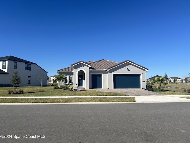 view of front of house with a front yard and a garage