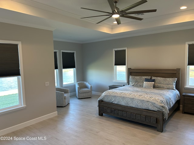 bedroom featuring multiple windows, ceiling fan, light hardwood / wood-style flooring, and crown molding