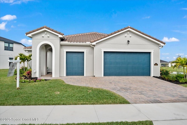 view of front of house with a front yard and a garage