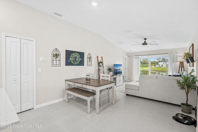 interior space featuring light tile patterned floors, vaulted ceiling, and ceiling fan