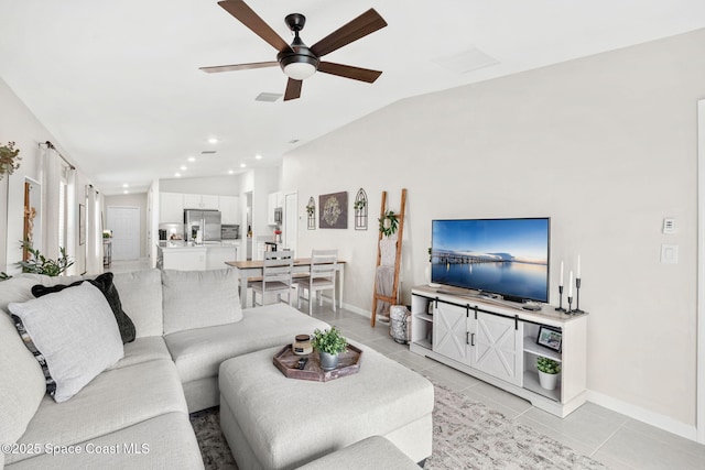 living room with lofted ceiling, ceiling fan, and light tile patterned floors