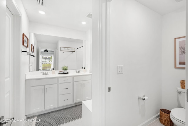 bathroom with tile patterned floors, vanity, and toilet