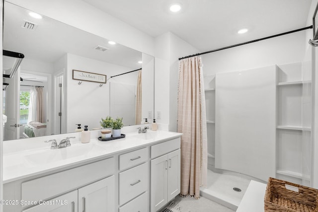 bathroom with curtained shower and vanity