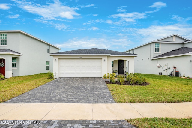 view of front of property featuring a garage and a front yard