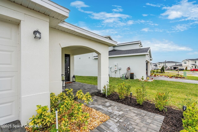 doorway to property featuring a lawn