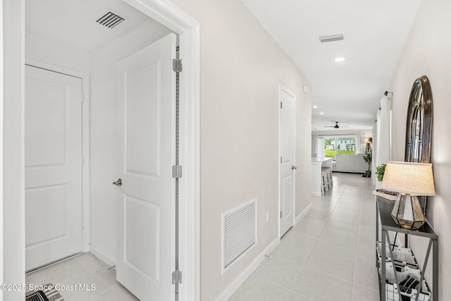 hall featuring light tile patterned floors