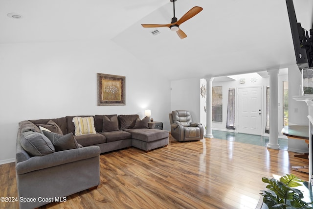 living room featuring hardwood / wood-style floors, decorative columns, ceiling fan, and lofted ceiling