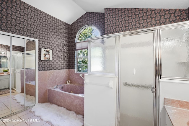 bathroom with plus walk in shower, vanity, tile patterned floors, and lofted ceiling