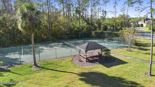 view of tennis court with a lawn