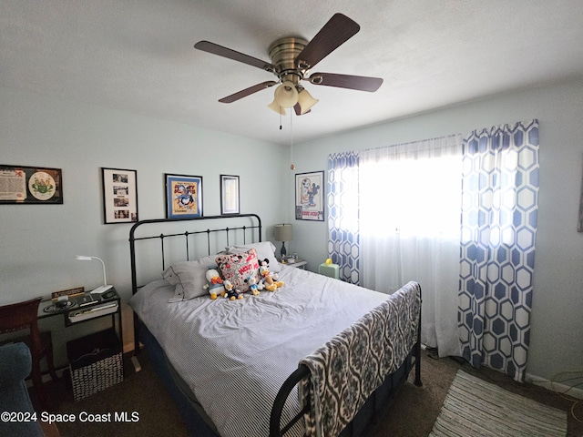 bedroom featuring dark colored carpet and ceiling fan