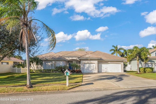 view of front of property with a front lawn and a garage