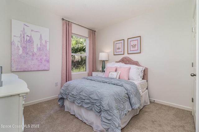 bedroom featuring light carpet