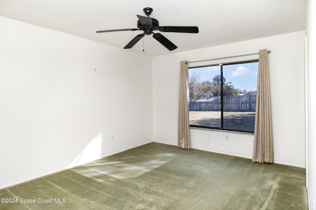 carpeted empty room featuring ceiling fan and a textured ceiling