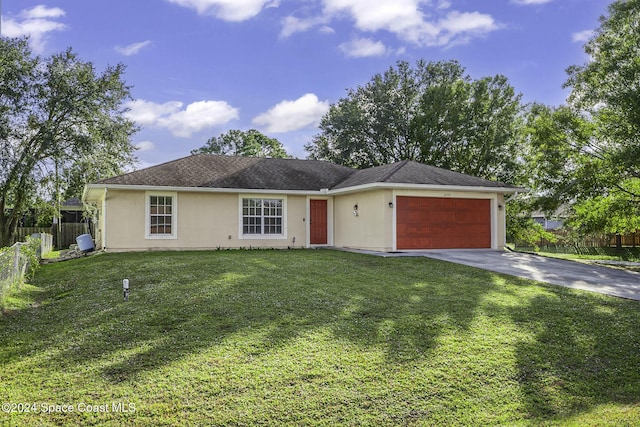 single story home featuring an attached garage, fence, a front yard, stucco siding, and driveway