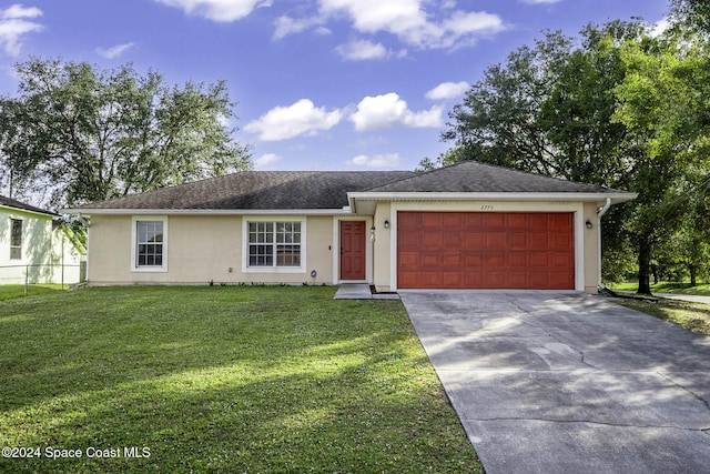 single story home with a front yard and a garage