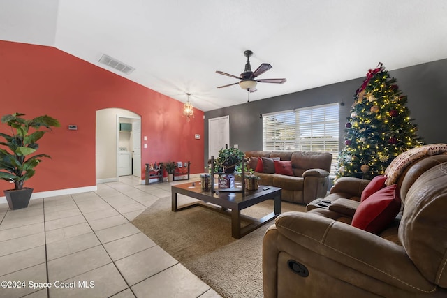 living room with washing machine and dryer, ceiling fan, lofted ceiling, and light tile patterned flooring