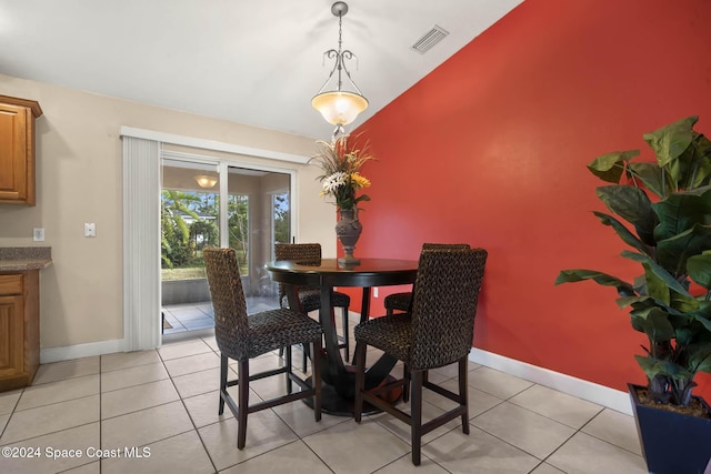 2773 San Filippo Dr SE, Palm Bay, FL 32909 - dining space featuring light tile patterned flooring and vaulted ceiling